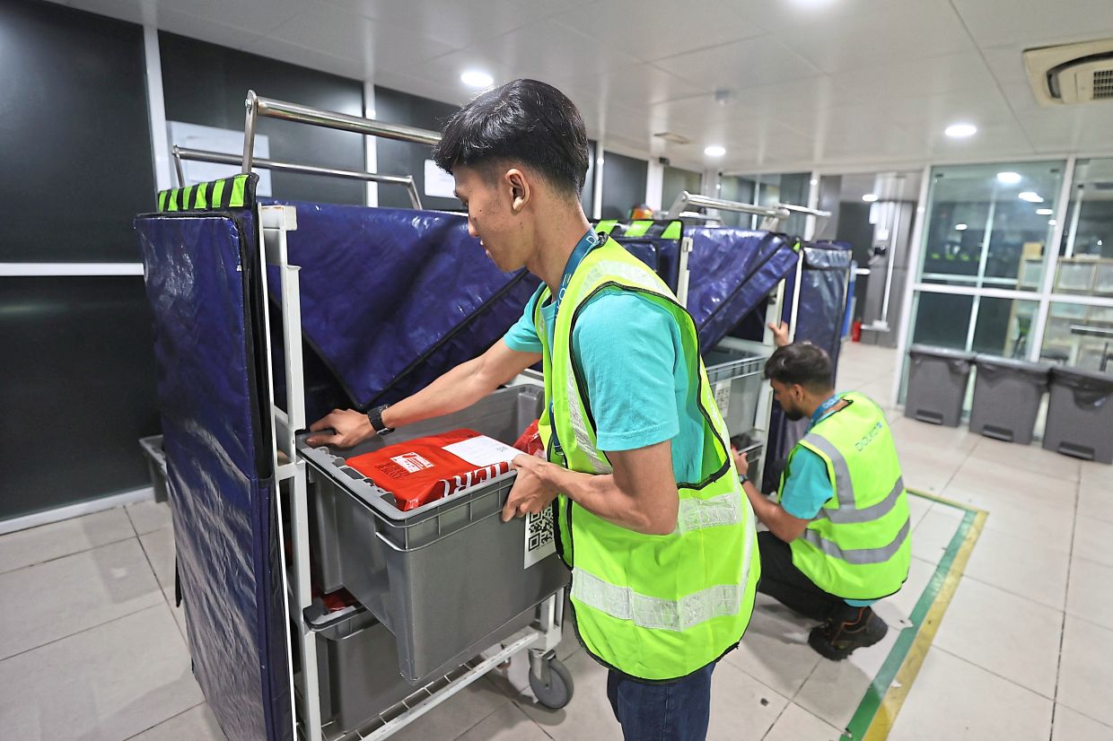 Parcels being sorted at Putra Heights LRT station for delivery